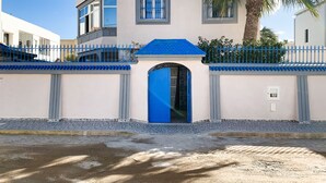 A modern building with a blue door, white walls, and a blue roof. - House with garden in a residential area 100 m from a magnificent beach (Unknown)