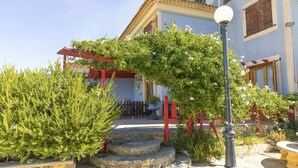 A stone staircase leading to a building entrance, surrounded by greenery and a lamp post. - Solano Penthouse – Los Cuatro Vientos Rural Retreat (Moratalla)