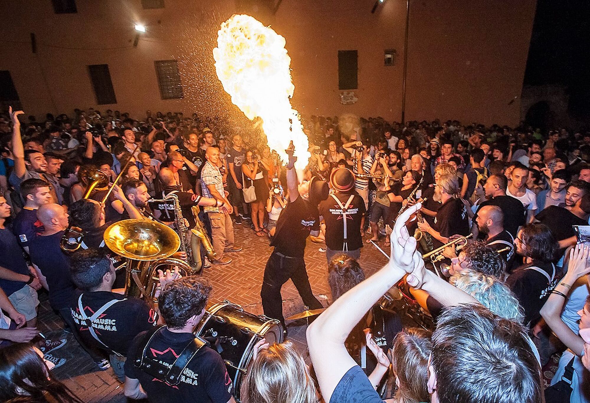A crowded indoor event with a brass band performing.