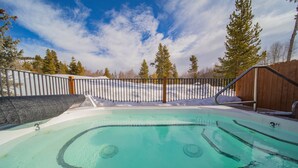 A swimming pool with a wooden deck and a metal fence. - Ground-Floor Unit w/Views, Close to Trails & Golf! (Keystone)