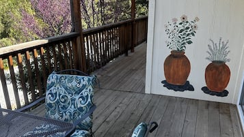 Relax in a serene outdoor space with a comfortable seating area featuring two chairs and a table.