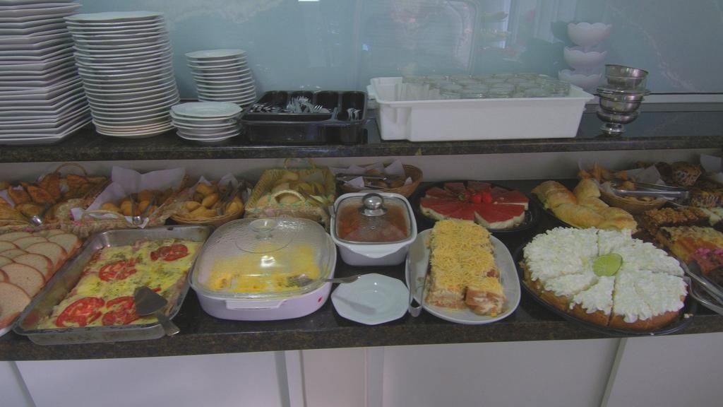 A buffet with various dishes including a casserole, a salad, and a fruit pie.