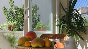 A table with a basket of fruits and a teapot on a tablecloth. - Apartment in Baška with Terrace, Air condition, WIFI (883-2) (Baška)