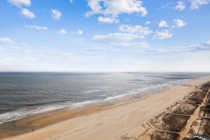 A beach with a clear sky and calm sea.