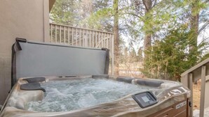 A hot tub with a control panel, surrounded by trees and a wooden deck. - At Base of Cottonwoods! * Private Hot Tub * Xbox (Cottonwood Heights)