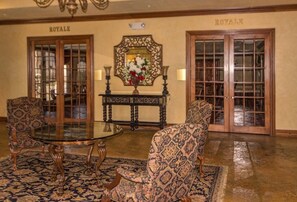 Experience the traditional luxury of our elegant lobby, featuring a grand mirror, ornate console table, and comfortable seating.