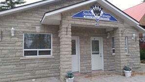 A stone building with a sign for 'Sittes of Wasaga' indicating weekly rentals.