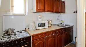 Enjoy cooking in this well-equipped kitchen with a gas stove, microwave, and coffee maker.
