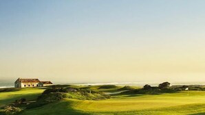 A golf course with a clubhouse and ocean view. - Villa with Books, Sun, Swing Bed, Private Pool And A Spacious Garden To Enjoy (Unknown)