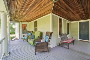 A covered porch with wicker furniture and a wooden ceiling. - Historic charm in downtown Tryon; 18 Minutes from Tryon Intl Equestrian Center (Tryon)