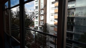 A view through a window with a metal railing, looking at a multi-story building with balconies and windows. - Elegante Apto en Polanco c-Terraza (Mexico City)
