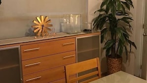 A compact kitchen with a wooden cabinet, a small table, and a potted plant. - Elegante Apto en Polanco c-Terraza (Mexico City)