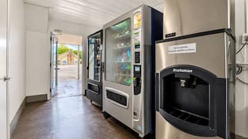 A hallway with vending machines and a Scotchman ice dispenser.