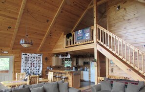 A spacious cabin with a loft bedroom, a dining area, and a kitchen. - Beatiful Custom Log Home " Bear Lodge" (Elizabethtown N.Y.)