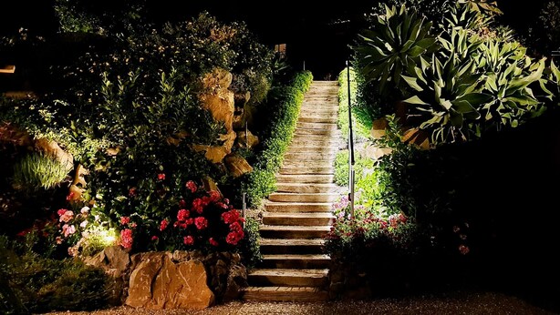 A stone staircase surrounded by lush greenery and flowers, leading up a hill. - Cyclope's House.  Amazing view and private mini SPA. (Vampolieri I)