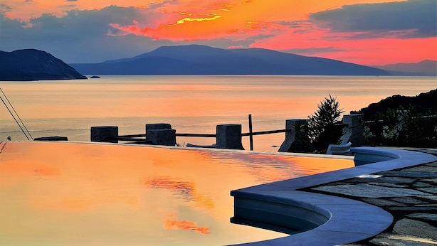 A pool with a view of the sea and mountains during sunset. - JASMINE house. Panoramic pool. Access to the sea. Privileged view of the Egean. (KLIMA)