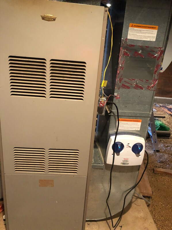A utility room with a large electrical panel and a generator.