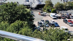 A marina with boats docked, a parking area, and a building in the background. - The Loft: Amazing views, parking & fantastic location! (Kingswear)