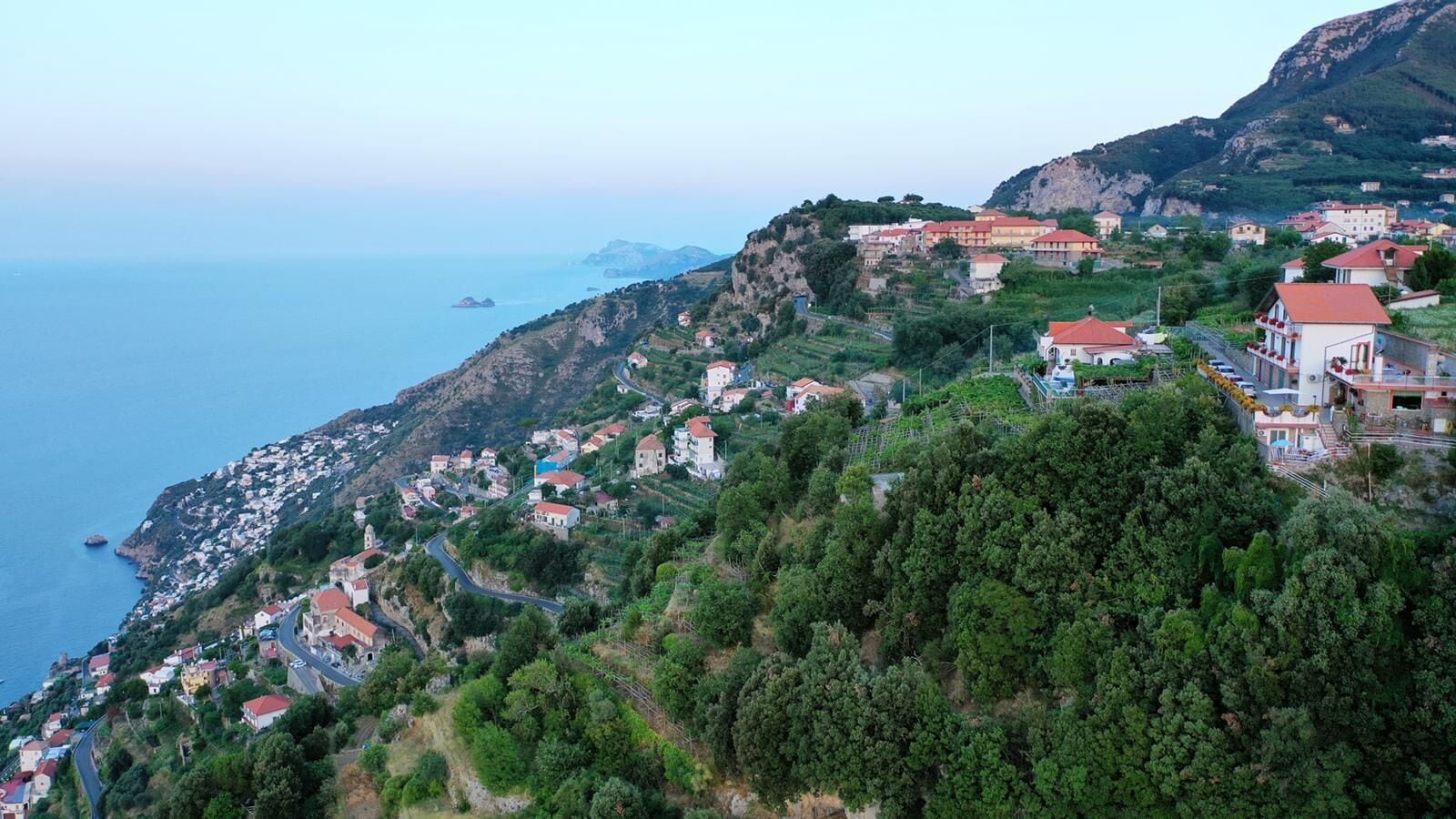 A coastal village with houses built on a hillside, overlooking the sea.