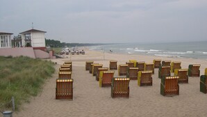 A beach with rows of wooden beach chairs and a lifeguard tower in the background. - COMPLETELY RENOVATED! NO PRICE INCREASE FOR 2026+2027 !!! BEACH CHAIR INCLUDED! (Binz)