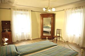 Classic bedroom with a double bed, nightstand, and mirror.