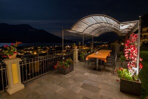 Enjoy dining or socializing on this outdoor terrace with a scenic view of the water and mountains.