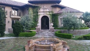 A house with a fountain in the front yard, a large arched doorway, and a tiled roof. - CASA VALENTINA-Beautiful Villa Estate (Whittier)