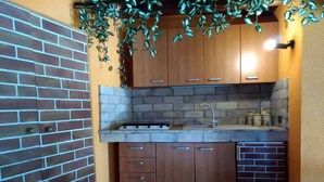 A kitchen with wooden cabinets, a built-in stove, and a sink. - Depandance Venera in Marsala with free wifi and air condition (Marsala)