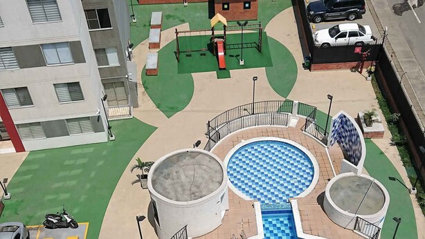 A rooftop pool with a checkered pattern, surrounded by a circular deck and a small play area. - APARTMENT IN NORTH PRADOS (Cali)