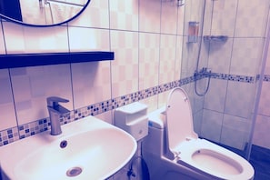 A bathroom with a sink, toilet, and shower. - Lu-Kang Traveler Inns (Lukang)