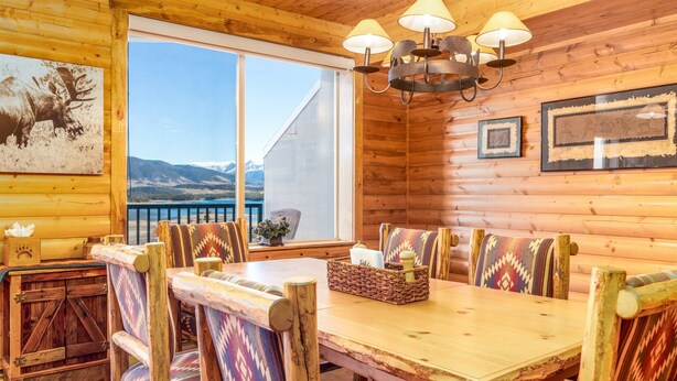 A wooden interior with a dining table, benches, and a chandelier. - Unique 7th Floor Penthouse. Views. Hot Tub Balcony (Frisco)