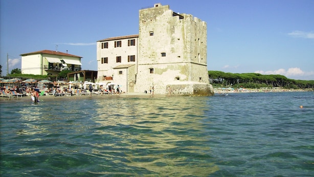 A coastal town with a prominent stone tower, beachside buildings, and clear blue waters. - Farmhouse Pescinone - Poppy, country and sea (Banditelle)