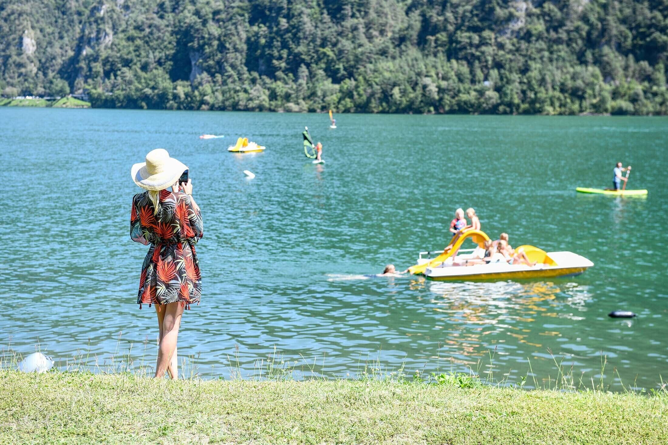 A lake with boats and people.