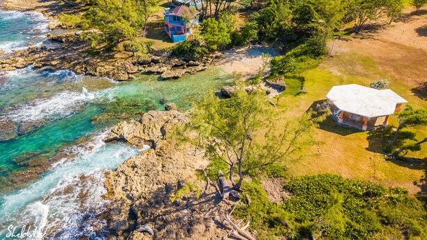 A coastal property with a house surrounded by trees, a beach, and rocky terrain. - Magical Romantic Getaway For 2, Lovers Paradise On Private White Sand Beach Cove (St Mary)