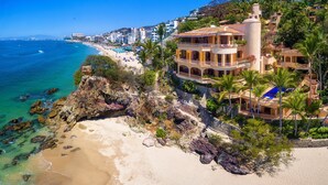 A coastal property with a beach, a pool, and a view of the ocean. - Villa Estrella Mar - 5 Star Luxury Villa - Staff - Private Pool - On the beach! (Puerto Vallarta)