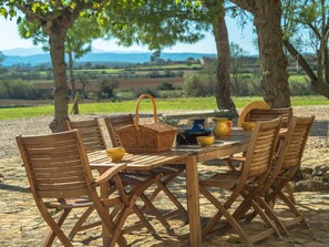 Enjoy al fresco dining amidst lush surroundings and a serene landscape.