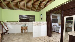 A room with a tiled floor, a wooden ceiling, a sink, a mirror, and a bed. -  Amazingly Affordable Savings "Rustic Jamaican Vibes" on Ocean Front, Selecluded (St. Mary, Jamaica)