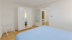 A bedroom with a bed, wardrobe, and a mirror. - Miramare House - Trilo 4 C (Mattinata)