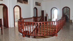 A grand staircase with a wooden handrail and balusters, leading to an upper floor. - Luxury retreats, destination weddings, family reunions and social events (Las Terrenas)