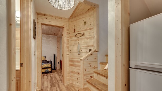 A wooden interior with a staircase leading to a second floor. - ~New~ Yellowstone Rock Studio (Gardiner)