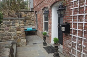Private front entry with a cozy seating nook and European courtyard for relaxing and entertaining.