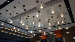 A modern interior with multiple hanging pendant lights and a central light fixture. - Le Hoteru (Kowloon)