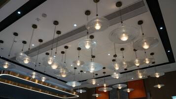 A modern interior with multiple hanging pendant lights and a central light fixture.