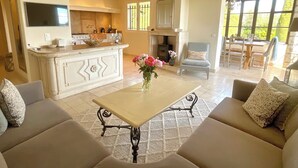 A spacious living area with a sofa, a coffee table, and a fireplace. - LUXURY 3 BED VILLA with AMAZING VIEW and PRIVATE HEATED POOL in GORGEOUS GARDENS (Mougins)