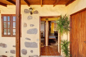 A rustic building with a stone facade, wooden beams, and a wooden door.