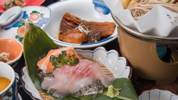 A variety of dishes on a table, including sushi and other Asian cuisine.