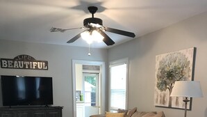 A living room with a ceiling fan, a television, a sofa, a coffee table, and a lamp. - Great Location!  Come Relax....Retreat!   (Kerrville)