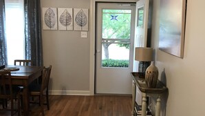 A dining area with a wooden table and chairs, a rug, and artwork on the walls. - Great Location!  Come Relax....Retreat!   (Kerrville)