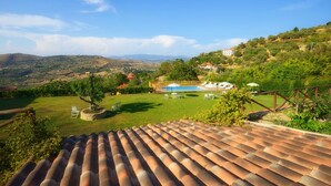 A pool area with a view of a hilly landscape.