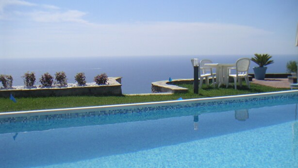 A swimming pool with a view of the ocean.